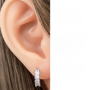 Detail of silver hoop earrings with shimmering white cubic zirconia pave setting
