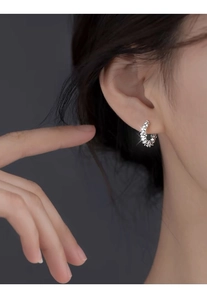 Close-up of S999 sterling silver hoop earrings with shimmering crushed stones on model