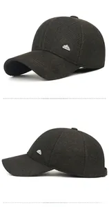 Detail of dark brown winter baseball hat featuring twill texture and silver mountain logo