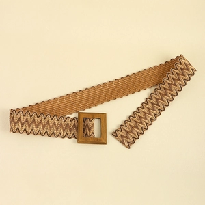 Detail of woven straw belt with wave patterns and a vintage square metal buckle