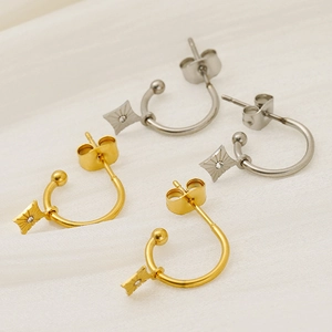 Macro shot of gold and silver stainless steel four-pointed star stud earrings set