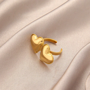 Gold titanium steel double heart open ring on champagne silk background for women
