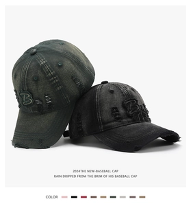 Close-up of vintage distressed baseball cap with 3D letter B embroidery and ripped details