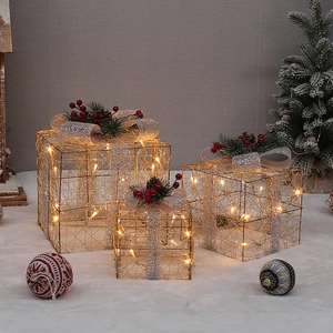 Three gold metal mesh lighted Christmas gift boxes with red berries and pine cones
