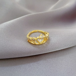 Detailed macro view of an adjustable crown heart ring with sparkling zircons in gold finish
