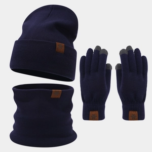 Close-up of snowflake leather labels and touch screen tips on navy knit winter set