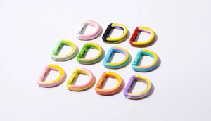 Close-up of colorful D-shaped spring buckles in various dual-tone spray finishes