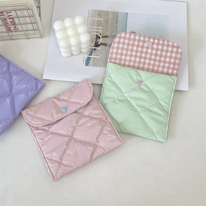 Quilted mini pouches in pink, green, and purple with diamond stitching and snap closure