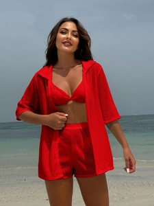 Detail of red 4-piece beach set featuring a crochet bikini and hooded cover-up outfit