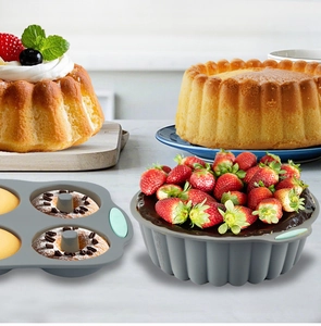 Macro detail of heat-resistant grey silicone cake mold set with muffins and bread