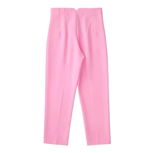 Detail view of pink high-waisted trousers with center crease and draped suit fabric