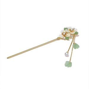 Classical gold hair pin with white shell petals, pearls and long tassels on white backdrop