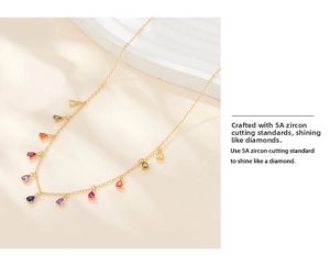 Macro detail of 5A grade multi-color teardrop zircon pendants on a golden chain necklace