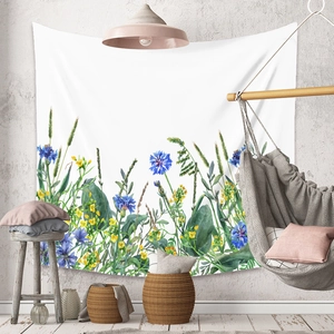Detail of floral tapestry with blue cornflowers on a wall in a bohemian room