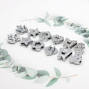 Silver 10mm sliding charm assortment with rhinestones for DIY bracelets on white background
