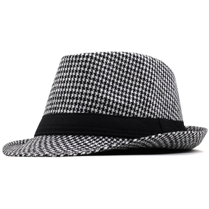 Detail of classic black and white houndstooth wool fedora hat with black decorative ribbon