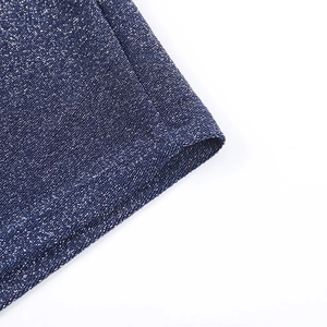 Detailed macro shot of navy blue glitter fabric showing stitching and shiny silver threads