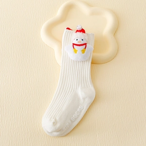 Detail of white cotton knit baby sock with 3D snowman doll and anti-slip bottom