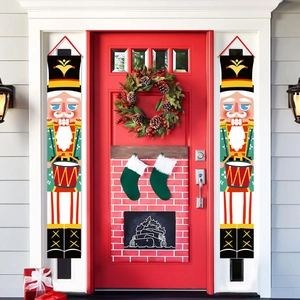Festive Nutcracker soldier door banners hanging on a red entrance for Christmas decor