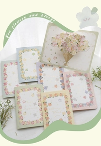 Macro detail of 3D floral pop-up greeting cards with pastel flower prints and textures
