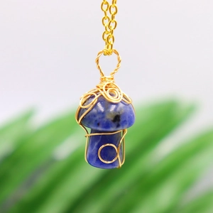 Detailed macro view of handmade wire-wrapped blue crystal mushroom pendant necklace