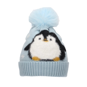Detail view of light blue knitted hat with a penguin pattern and a fluffy pom-pom top