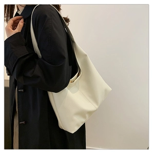 Grande borsa tote minimalista bianco crema in pelle PU indossata dal modello