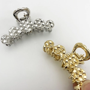 Elegant woven alloy hair claw clips in metallic gold and silver finish on white background