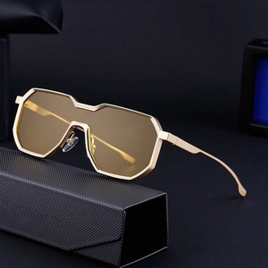 Steampunk irregular shield sunglasses with gold metal frame and amber lenses on a black case