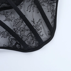 Detailed macro shot of intricate black floral lace mesh and structural ribbon stitching