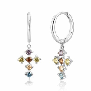 Macro detail of S925 silver hoop earrings featuring colorful zircon cross pendants