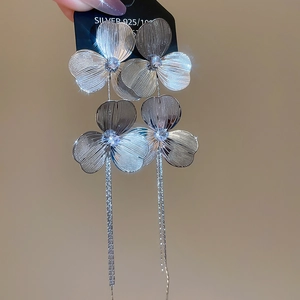 Detail of S925 silver flower tassel earrings featuring hollow petals and cubic zirconia stones