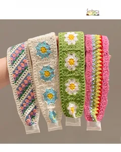 Detail of four handmade crochet flower headbands showing woven texture and patterns
