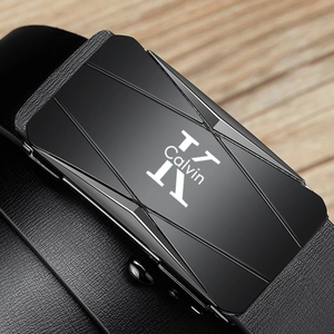 Close-up of black leather belt with matte metal automatic buckle and logo detail