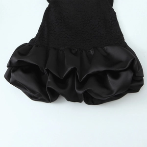 Elegant black short dress featuring lace patchwork and ruffled satin hemline