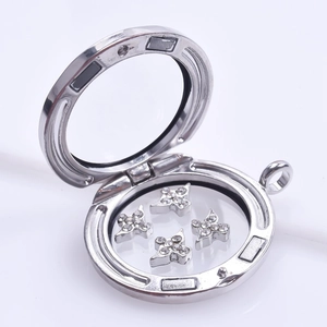 Detailed view of silver floating charm locket with star charms and magnetic closure