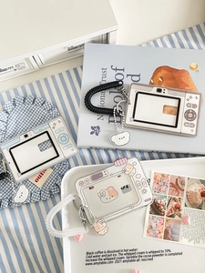 Detail of camera-shaped acrylic card holders with spiral lanyards and cute charms