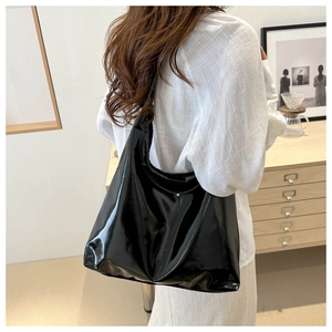 Minimalist black glossy soft PU leather tote bag shown from a stylish side view profile