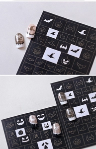 Macro view of Halloween nail stencils with pumpkin and ghost patterns for airbrushing