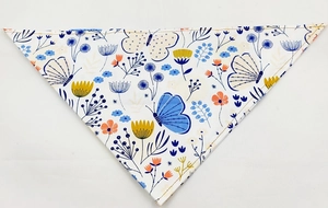 Detail of pet bandana with delicate butterfly and floral patterns on breathable cotton fabric