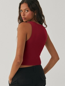 Detail shot of a slim fit burgundy Y2K crop top showing the ribbed fabric and racerback cut