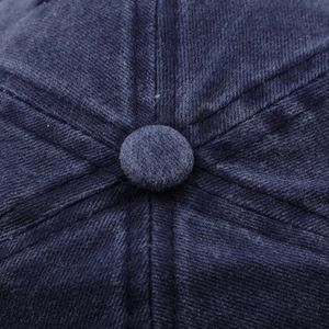 Macro detail of navy washed cotton twill fabric and top squatchee on baseball cap