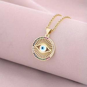 18K gold plated evil eye pendant necklace with colorful zircons on pink fabric