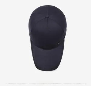 Top down view of a navy blue baseball cap with six-panel design and side metal badge