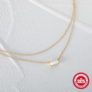 Close-up of gold S925 sterling silver double layer necklace with square zircon stone