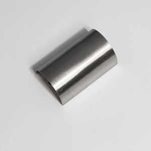 Detail of silver metallic hair hook featuring a sleek brushed texture and curved shape