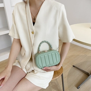 Fashionable light green structured box bag with vertical stripes and gold chain strap