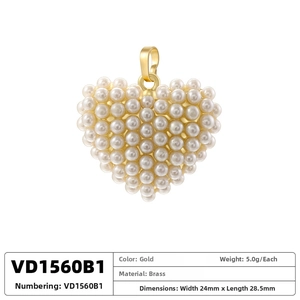 Detail of heart-shaped pendant crafted with white pearls and a gold brass connector