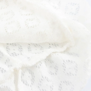 White knitted halter dress with round lace patterns and drawstring texture detailing