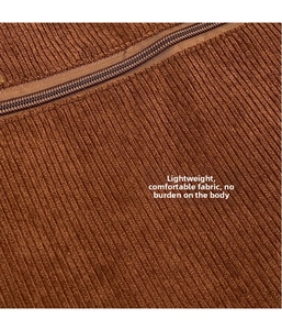 Close-up of brown corduroy fabric texture and durable zipper on large shoulder bag